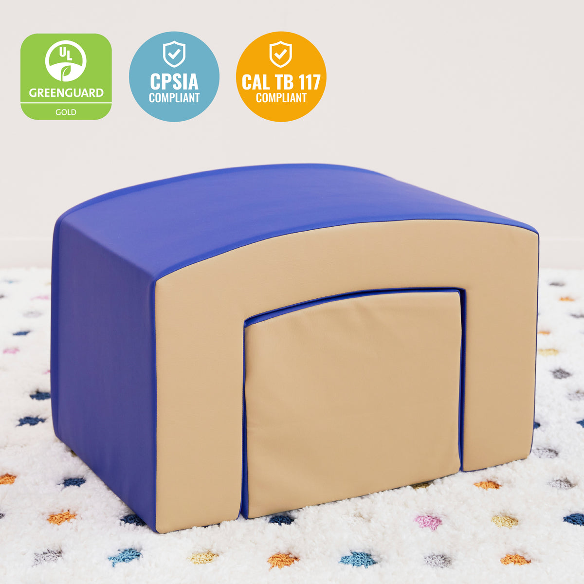 Blue and tan foam tunnel with curved blue top sections and yellow ramp climber piece on checkered floor.