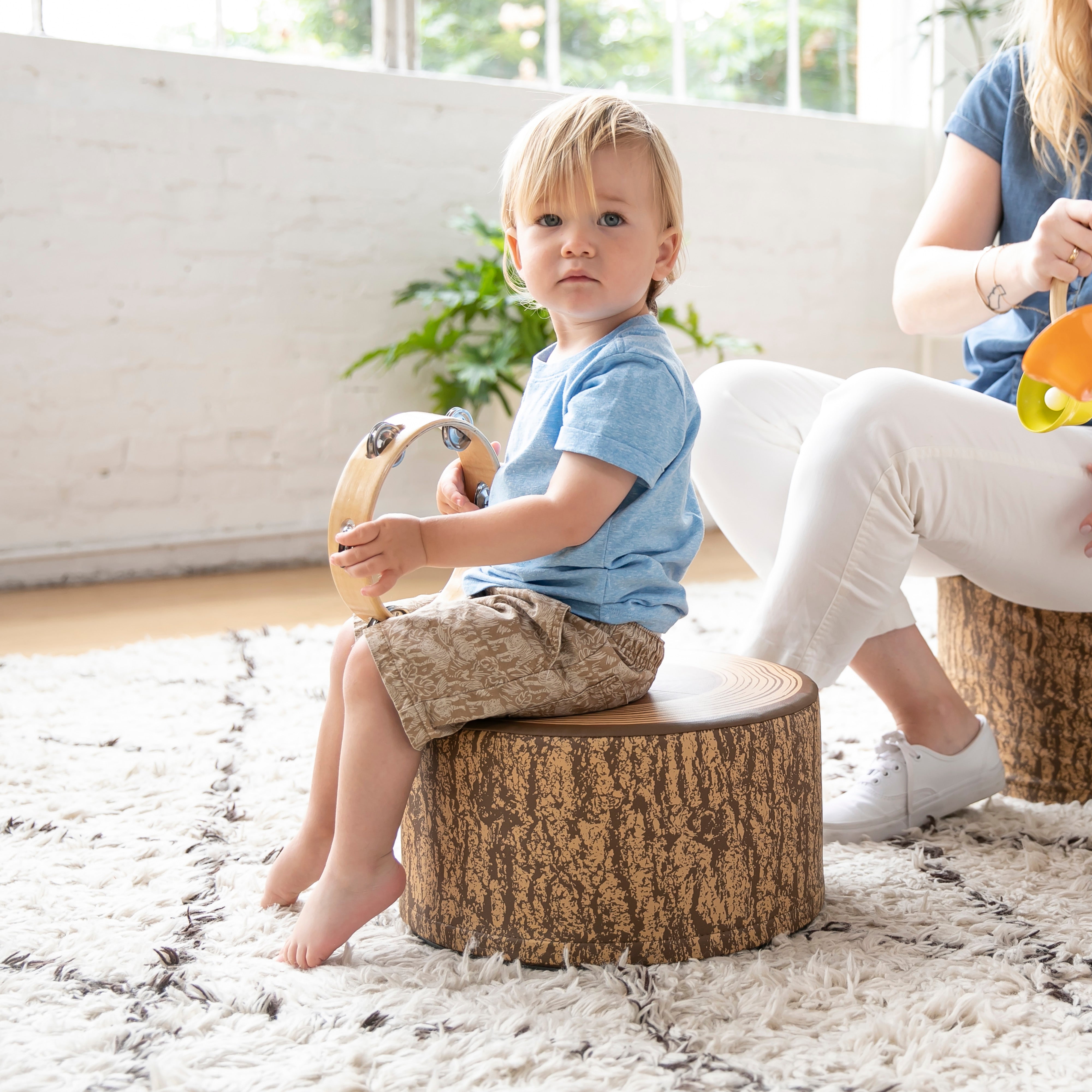 Preschool Nature-Inspired Reading Circle with Tree Log Seating and Book Display