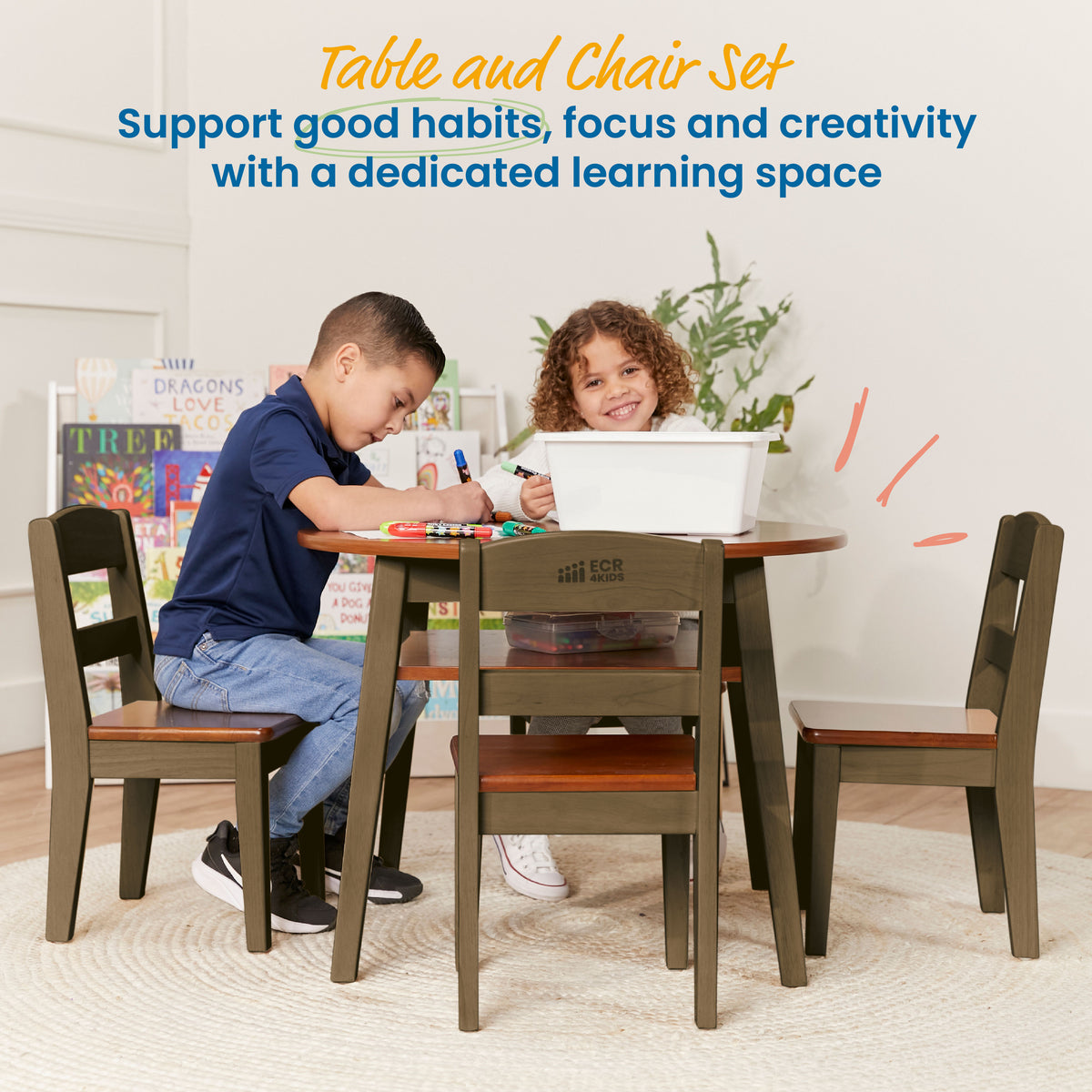 Olive green wooden table and four matching chairs with orange-brown seats, occupied by two children drawing and playing.