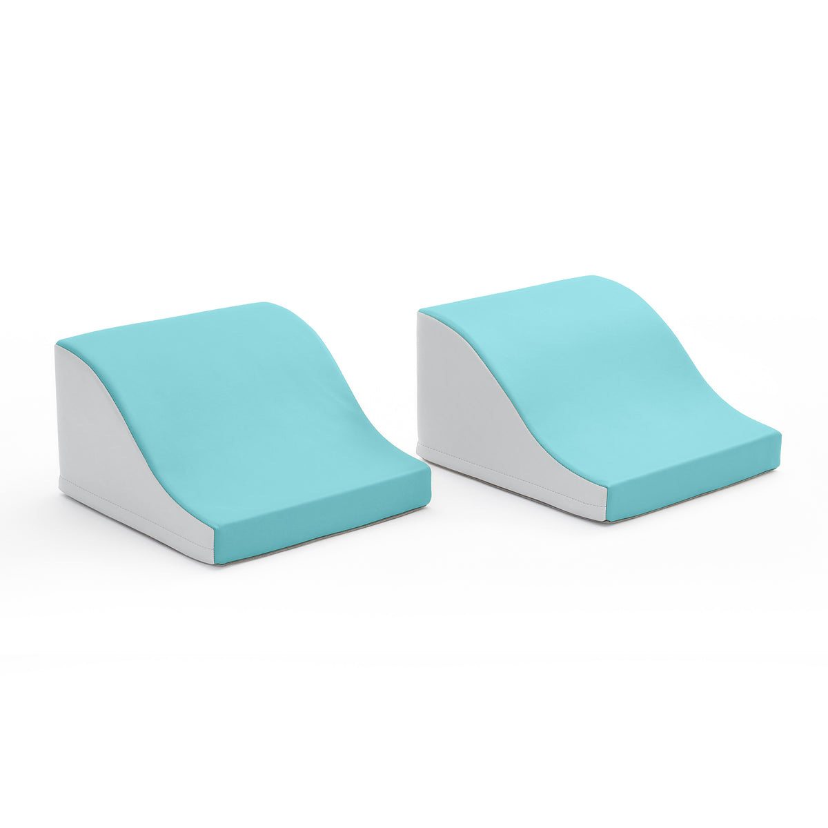 Two turquoise and white foam climbing wedges with curved wavy tops and angled bases.
