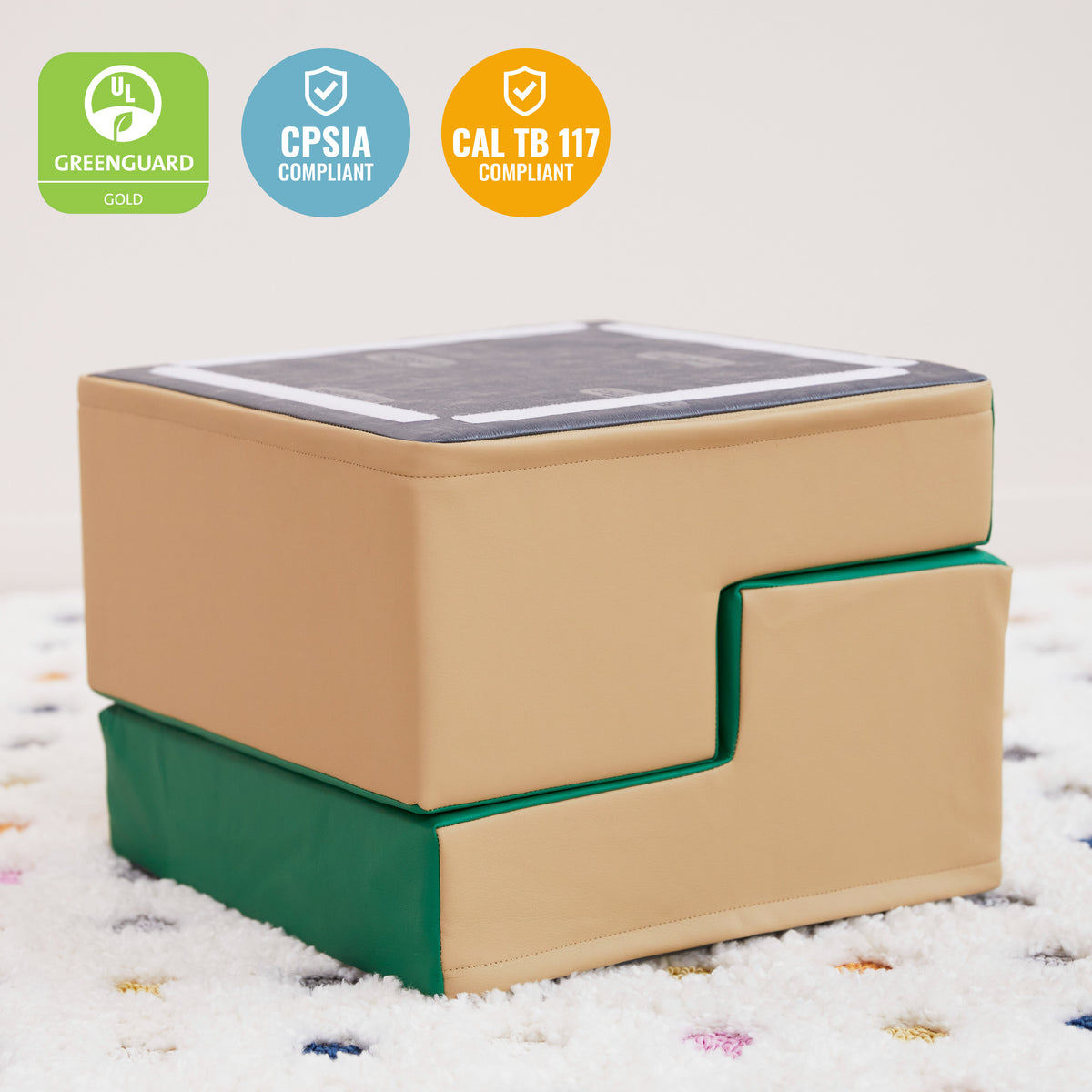 Tan and green foam stepping stool with dark gray non-slip top surface and pull-out green step.